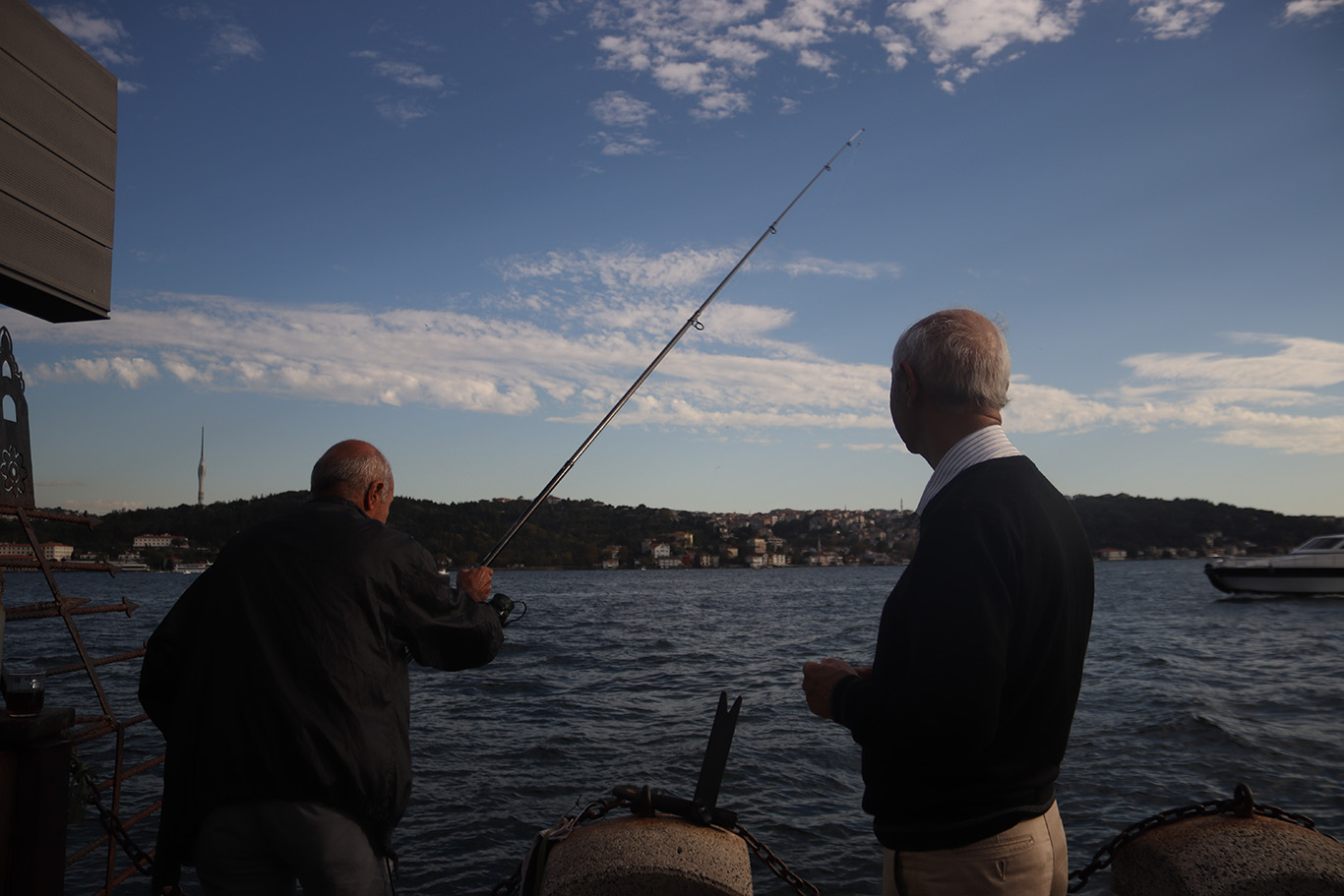 Two elderly men fishing near the Bosphorus Strait.