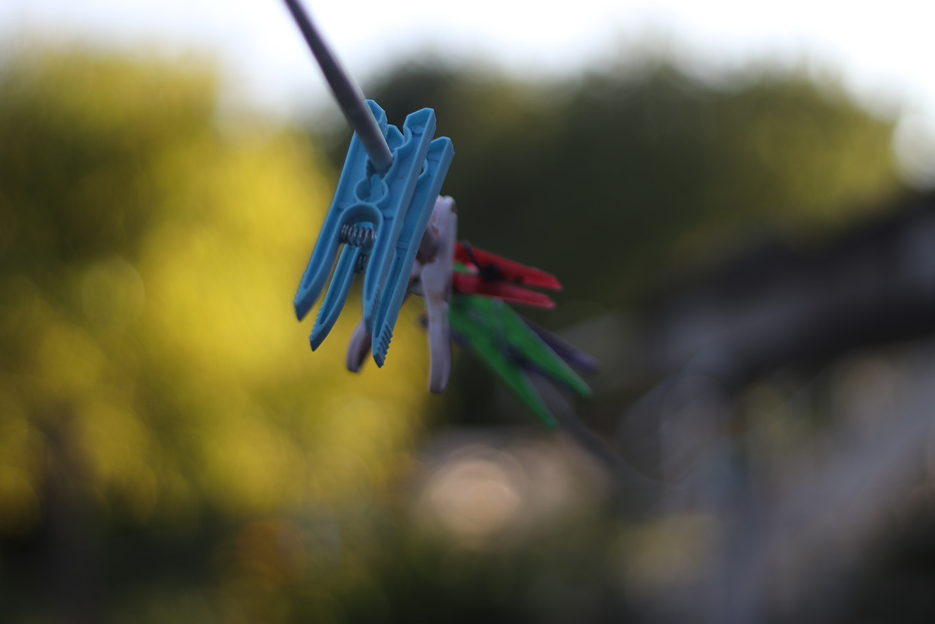 Colourful clothespins on a clothesline.