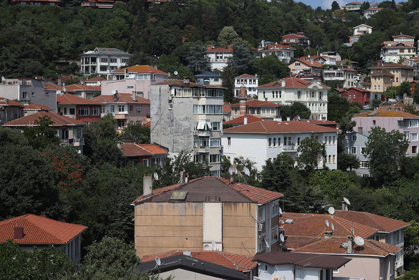 Apartment complexes with brick roofs scattered around in greenery.